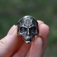 Angled shot of the skull ring, highlighting the deep-set eyes and intricate facial bone structure.