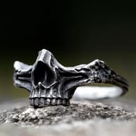 Detailed front view of the men's steel skull ring, showcasing intricate carvings.