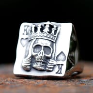 Angled view of gothic crown skull poker ring highlighting the deep engraved relief