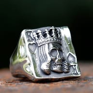 Top-down view detailing the antiqued King playing card skull design on stainless steel