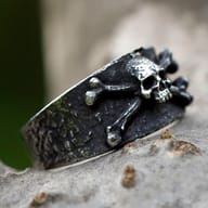 Side view of the distressed 316L stainless steel ring, highlighting the textured band and bone details.
