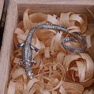 Stainless steel crocodile ear cuff earring worn on ear demonstrating wrap fit