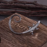 Side profile view of gothic crocodile ear wrap earring highlighting scale pattern