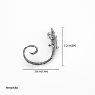Stainless steel crocodile ear wrap earring displayed on dark textured background