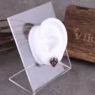 Gothic winged skull red stone stud earring shown worn on an ear to illustrate scale and placement