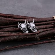 Close-up front angle of detailed horned devil mask stud earring in stainless steel