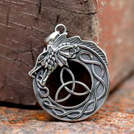 Close-up of detailed dragon scales and Celtic knotwork on round steel amulet