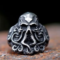 Detailed close-up of the skull head with empty eye sockets on the octopus ring.