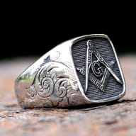 Top-down view of the square Masonic symbol on a men's ring.