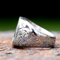 Detail view of Masonic ring showing intricate scrollwork on the side band.