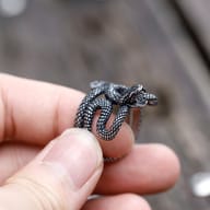 Detailed close-up of the snake's textured body on the 316L stainless steel ring, showing individual scale patterns.