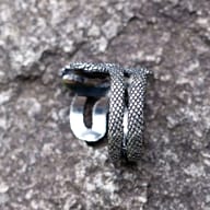 Close-up view of the coiled body of the 316L stainless steel snake ring, highlighting textured scales.