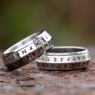 Angled view showing the antique weathered finish of the rune spinner ring