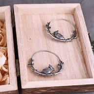 Stainless steel raven hoop earring showing the slim hoop wire and clasp mechanism