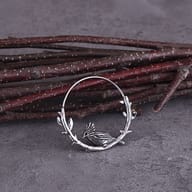 Pair of 316L stainless steel raven branch hoop earrings laid flat on a neutral background