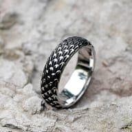 Men's 316L stainless steel Viking dragon scale ring on a textured grey surface.