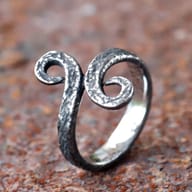Textured surface detail on the bottom curve of the men's Troll Cross ring.