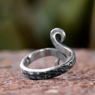 Close-up of the lower swirl of the 316L stainless steel Troll Cross ring.