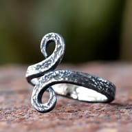 Close-up of the upper swirl of the Norse Troll Cross ring, showcasing its textured surface.