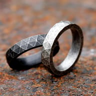 Angled view highlighting both the textured surface and runic inscriptions of the robust Viking ring.