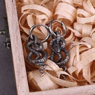 Close-up of the textured snake scale detailing on the stainless steel serpent earring