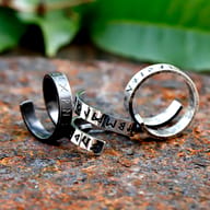 Detailed shot of the men's Viking rune ring, highlighting the oxidized finish and runic script.