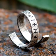Top-down perspective of the retro rune ring on a dark background, showcasing its full design.