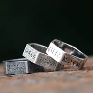 Angled view of the rugged stainless steel hexagon ring, highlighting its textured surface and etched runes.