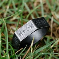 View of the stainless steel hexagon ring from a slight angle, focusing on the robust metal and carved runes.