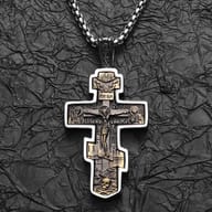 Lower-left intricate details of the Orthodox Crucifix pendant with figures and symbols.