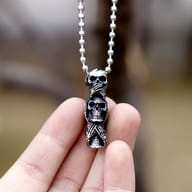 Side profile of the solid 316L stainless steel three skulls pendant