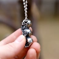 Three skulls pendant displayed with stainless steel chain options
