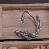 Stainless steel fish ear cuff displayed to show fit and contour for the ear