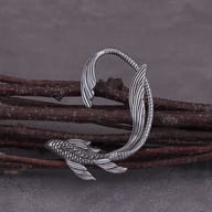 Close-up detail of textured scales and fins on a gothic fish ear cuff