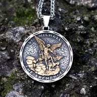 Men's stainless steel Archangel St. Michael guardian pendant necklace on a mossy rock.