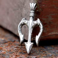 Front view of vintage 316L stainless steel trident pendant resting on a rustic surface