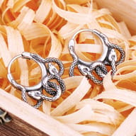 Close-up of the lower section of both 316L stainless steel snake hoop earrings, focusing on the textured snake bodies.