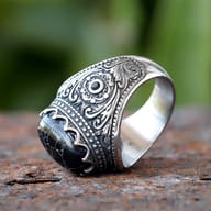 Angled shot of the vintage stainless steel ring showing both the black zircon and band details.