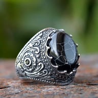 Close-up of the cracked black zircon stone set in a vintage stainless steel ring.