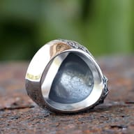 Frontal close-up of the vintage stainless steel ring highlighting the black zircon and ornate bezel.