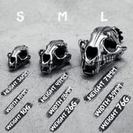 Angled shot of the 316L stainless steel saber-toothed tiger skull pendant from the front-side.