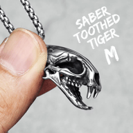 A different perspective of the saber-toothed tiger skull pendant, showing its three-dimensional form.
