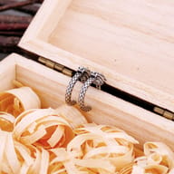 Top-down view displaying the antiqued silver finish of the dragon hoop earrings