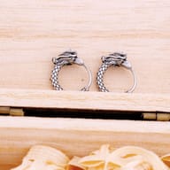Side profile showing the curved shape and clasp of the dragon hoop earring