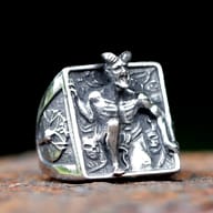 Side view of stainless steel devil ring displaying ornate side band detailing and rugged finish