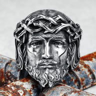 Side profile of the Jesus face ring, emphasizing the rugged stainless steel finish and the depth of the carving.