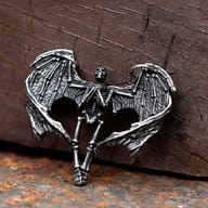 Close-up of the gothic winged skeleton pendant's head and left wing showing intricate details.