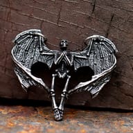 Detailed view of the textured right wing and upper skeleton of the gothic pendant.
