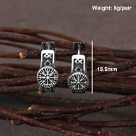 Angled view of the Viking compass earrings highlighting the polished finish and dark contrast