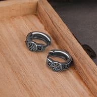 Close-up of the Vegvisir compass medallion on the stainless steel hoop earring